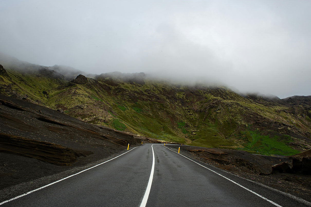 A road with a solid white centre line