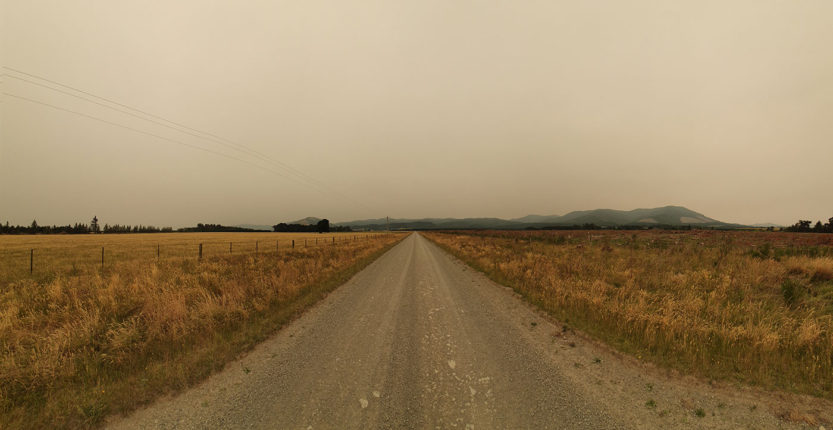 Panorama of Cantebury farmland with Australian fires smoke haze