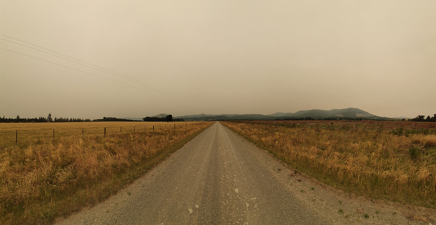 Panorama of Cantebury farmland with Australian fires smoke haze
