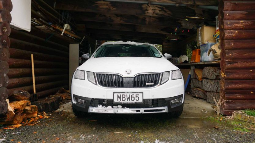 ŠKODA Octavia Scout in white parked in a log cabin