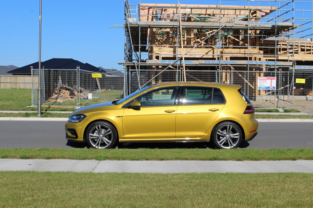 Side shot of the Golf R-Line in Turmeric on the road